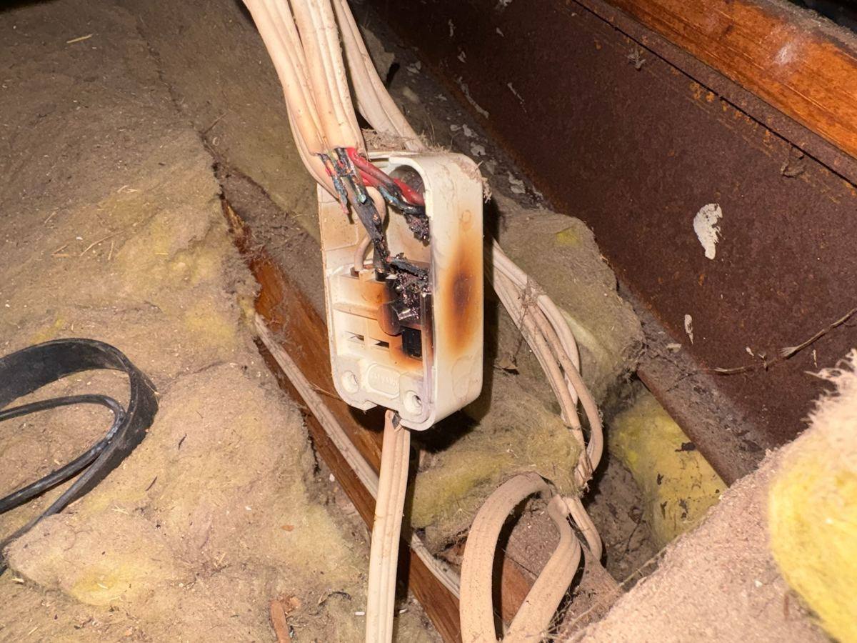 Burnt electrical socket in a Perth roof cavity, real fire risk found by Buetec Electrical